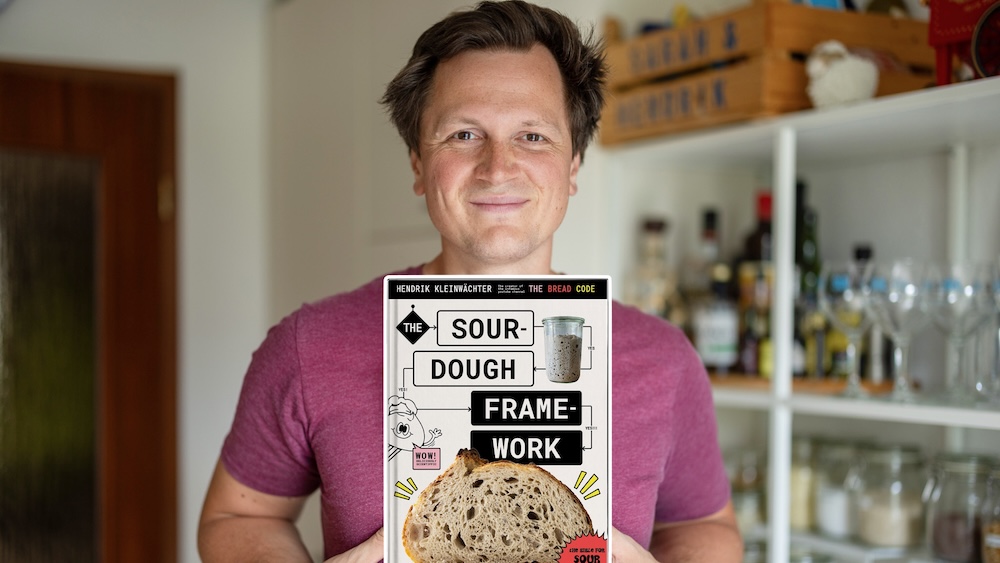 Hendrik, the creator, holding a copy of The Sourdough Framework book